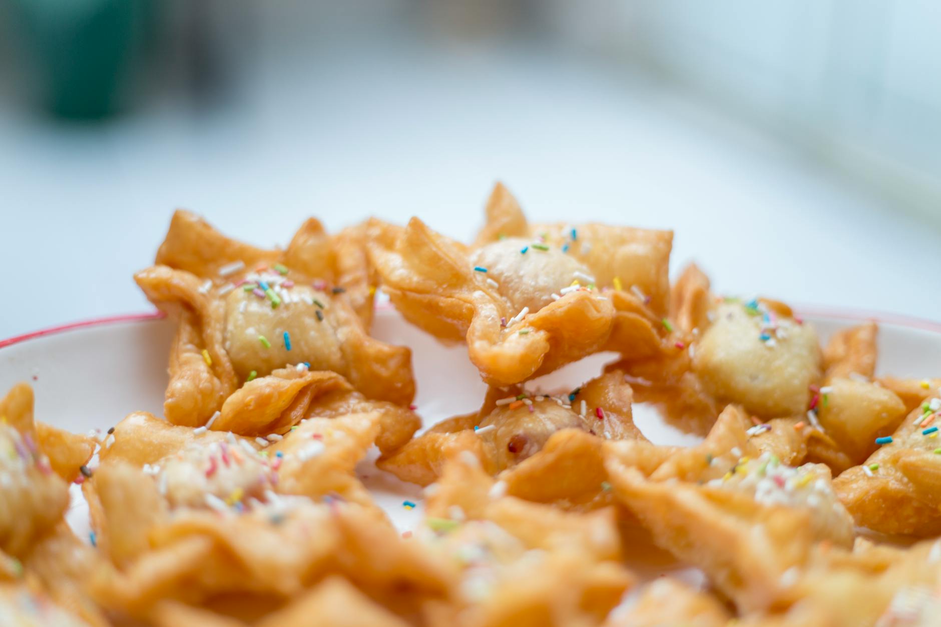 Delicious traditional Argentine pastries sprinkled with colorful toppings on a plate.