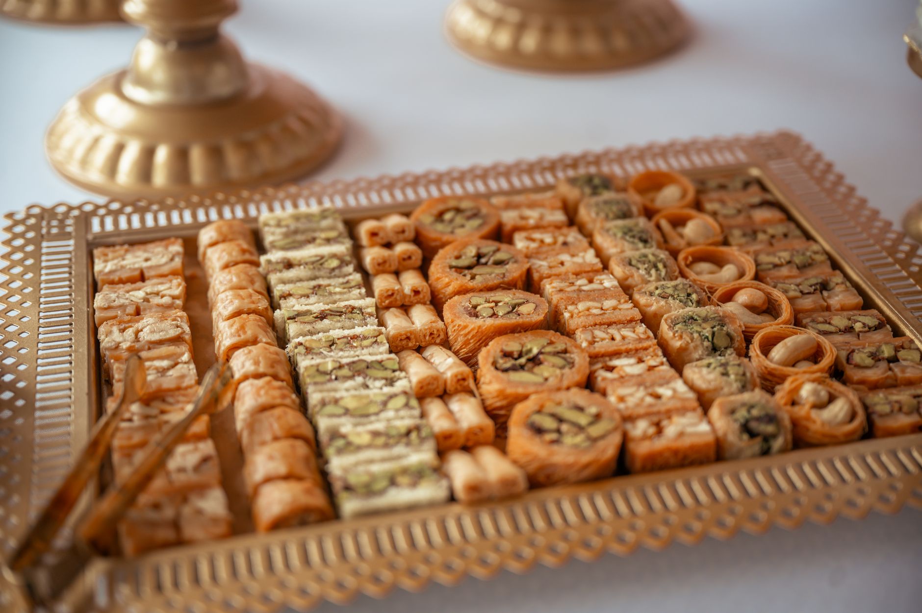 Close-up of assorted sweet Middle Eastern pastries elegantly arranged on a decorative tray.